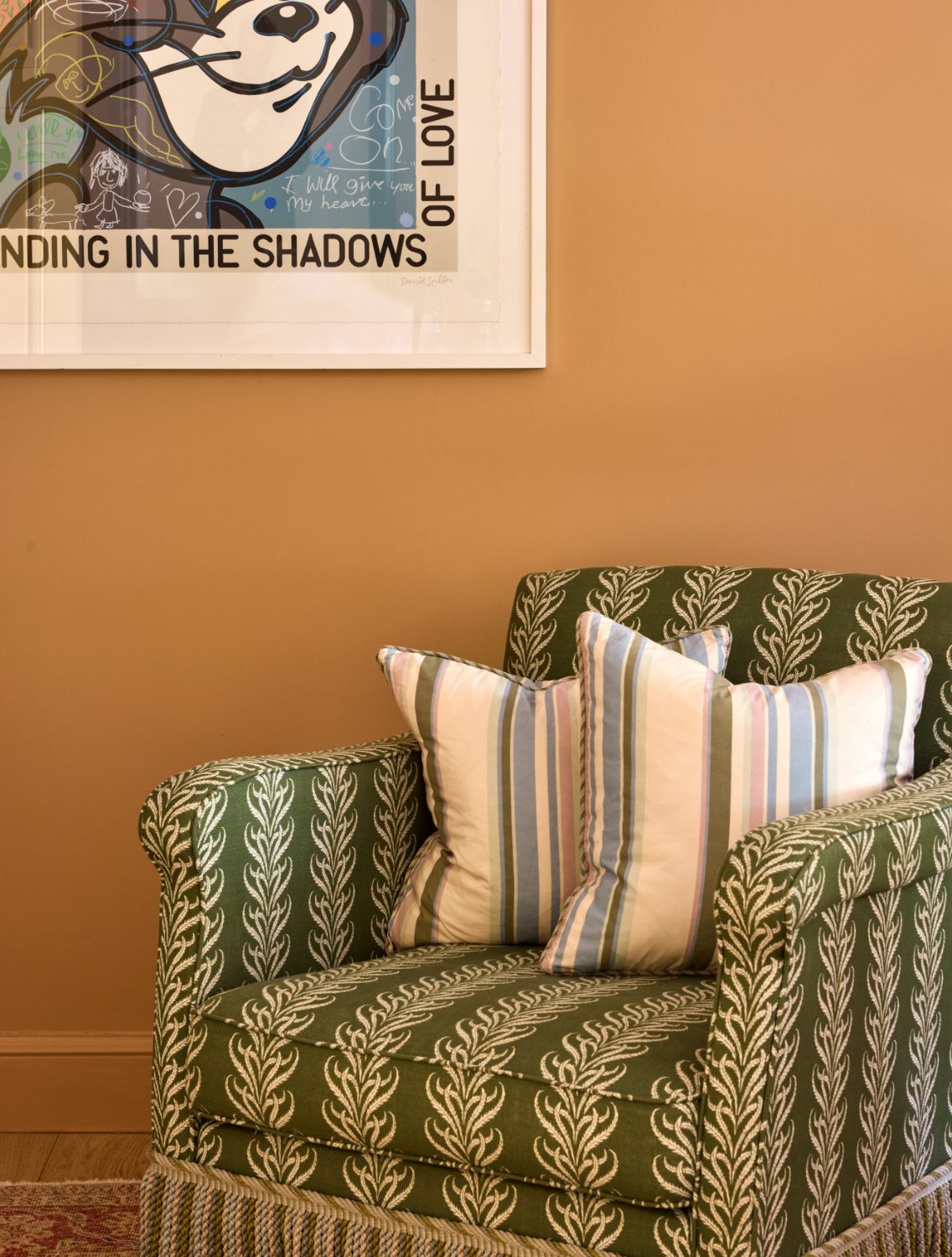 Green armchair in leaf stripe fabric